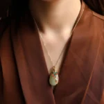 White jade peacock pendant necklace worn on neck, gold chain with colorful enamel peacock design, daily styling showcase