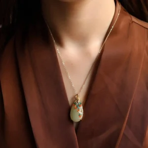 White jade peacock pendant necklace worn on neck, gold chain with colorful enamel peacock design, daily styling showcase