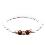 White jade 7mm round beads protection bracelet with red string and gold spacer accents, flat lay top-down view on white background