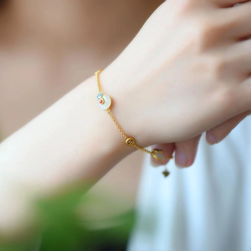 White jade copper bracelet worn on female wrist as lifestyle shot, showing slim gold chain and delicate hanging tail charm for protection