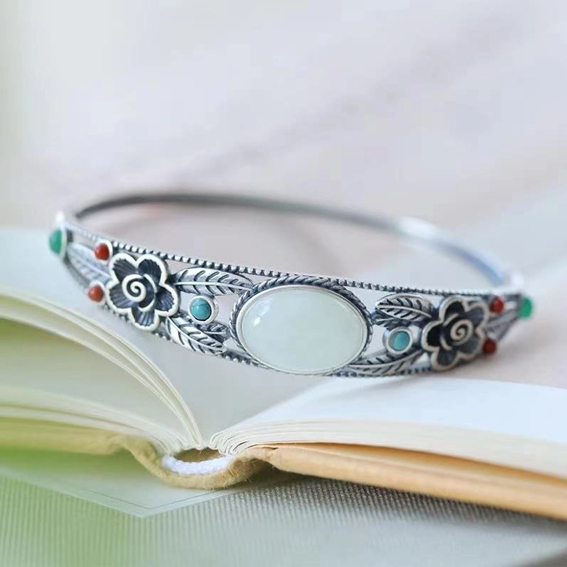 White jade and silver bangle with delicate floral filigree, premium hinged buckle closure, elegant minimalist design