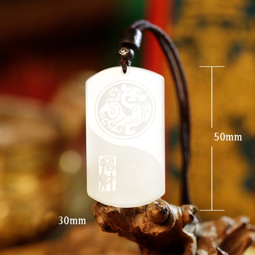 White jade protection pendant with wealth symbol detail shot showcasing handcrafted natural jade finish