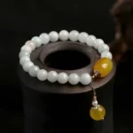 White jade yellow agate red agate protection bracelet overhead view with natural gemstone beads