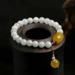 White jade yellow agate red agate protection bracelet overhead view with natural gemstone beads