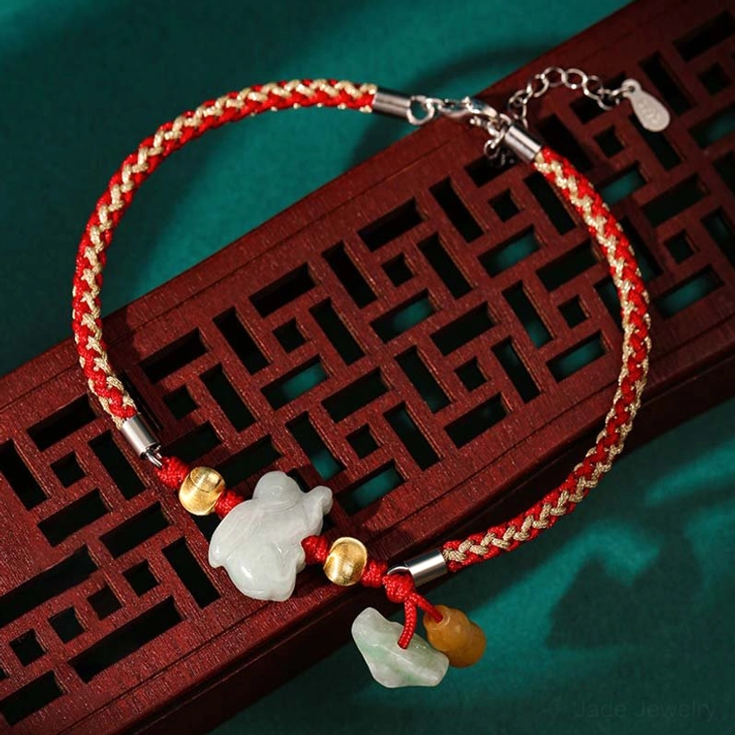 Adjustable zodiac jade bracelet featuring white jade charm, dual jade pendants, braided red cord, and silver chain extension clasp