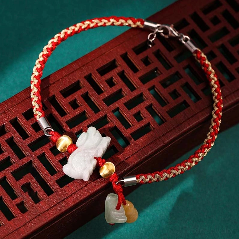Zodiac jade prosperity bracelet with white jade charm, yellow jade pendant, mixed red-gold braided rope, and silver clasp