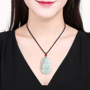 Zodiac Natal Buddha jade necklace worn around neck with red bead spacer detail, showing authentic jade pendant on black outfit
